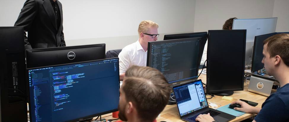 A team of developers collaborating on API security in a modern workspace