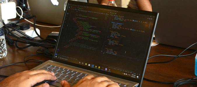 A group of developers collaborating with laptops, representing teamwork and secure API data transfer