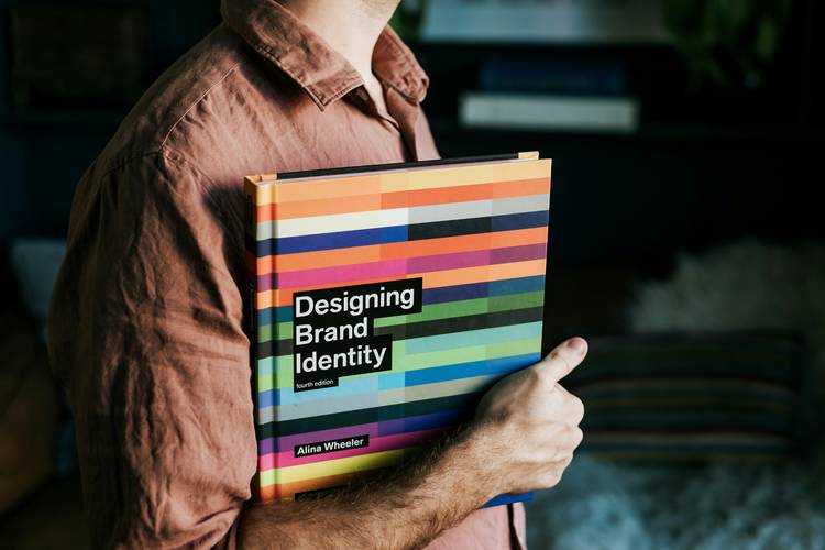 A visual showing a brand book with logo and color palette pages, representing branding guidelines