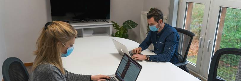 A modern office team reviewing a calendar and planning business days on a digital device