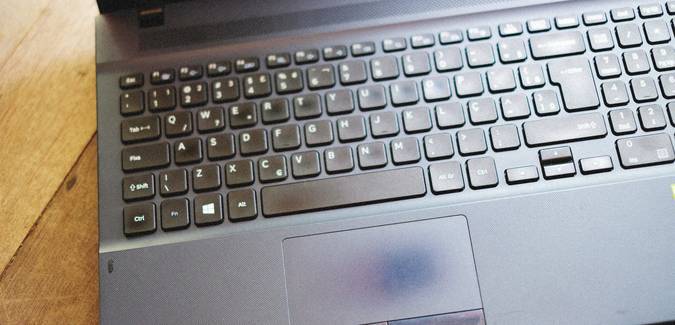 A closeup of a cookie beside a laptop showing a website privacy settings screen, symbolizing cookies on websites