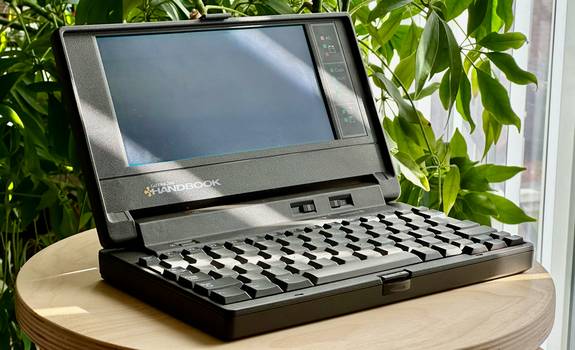 An open laptop with a spreadsheet and text editor, representing CSV editing and validation