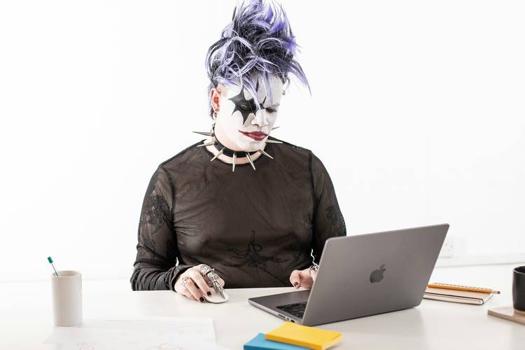 A digital creator at a modern workspace reviewing content licensing paperwork