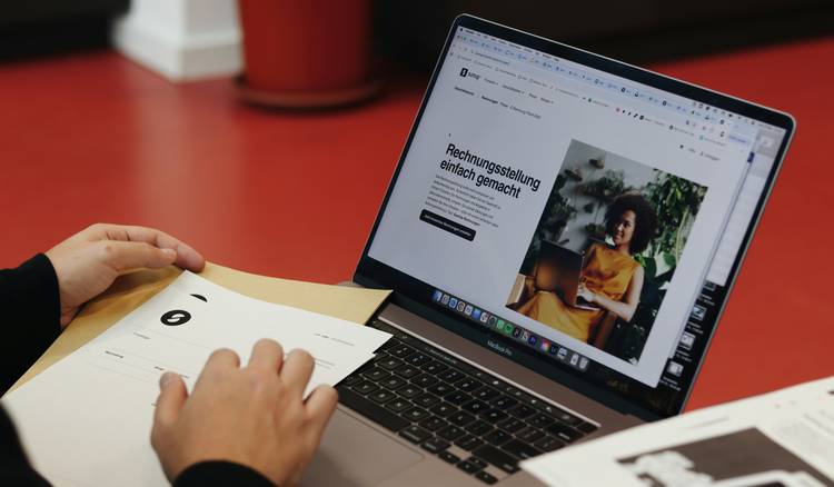 A business professional composing an email with a visible signature block, illustrating digital branding
