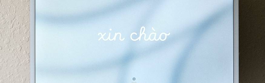 A modern workspace with a digital business card and email on screen, representing professional email signature creation