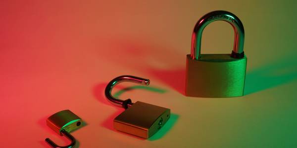 Concept image representing the difference between hashing and encryption, such as two lock icons and a unique fingerprint