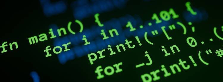 A closeup of a programmer at a computer working with hexadecimal and decimal values, with code and digital numbers visible