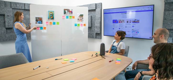 A diverse team collaborating on accessible web design with assistive technology devices in an inclusive workspace