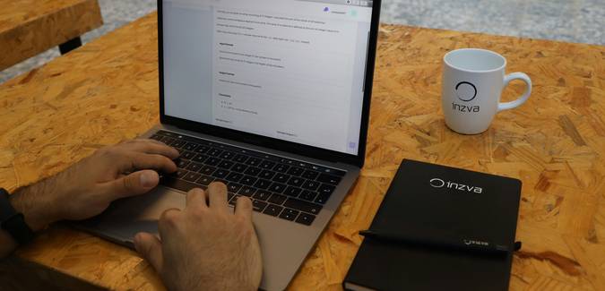 A developer reviewing JavaScript code on a laptop in a modern workspace