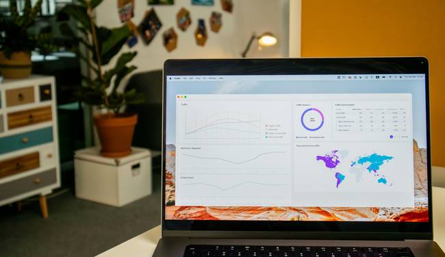 A modern workspace with code on a laptop, visualizing data minification in action