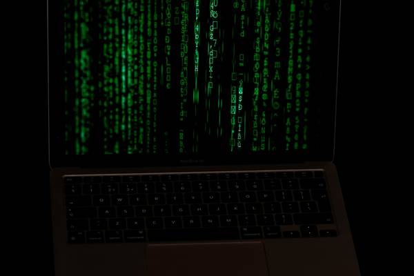 A digital padlock, abstract binary code background, and a password field representing modern online security