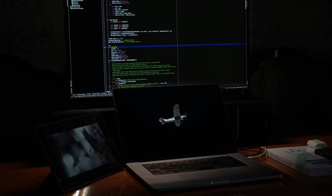 A developer working at a computer with code on the screen, symbolizing regex pattern testing and debugging