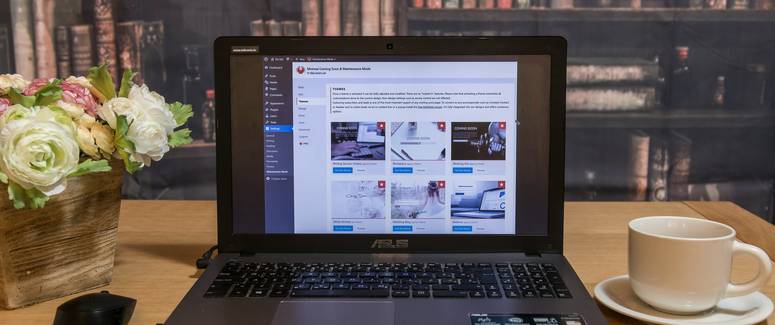 A laptop with a responsive HTML email open, showing both desktop and mobile previews in a workspace