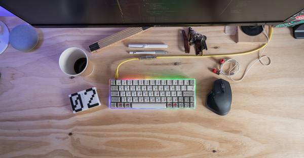 RGB and Hex color swatches on a designer's desk with a computer and color samples