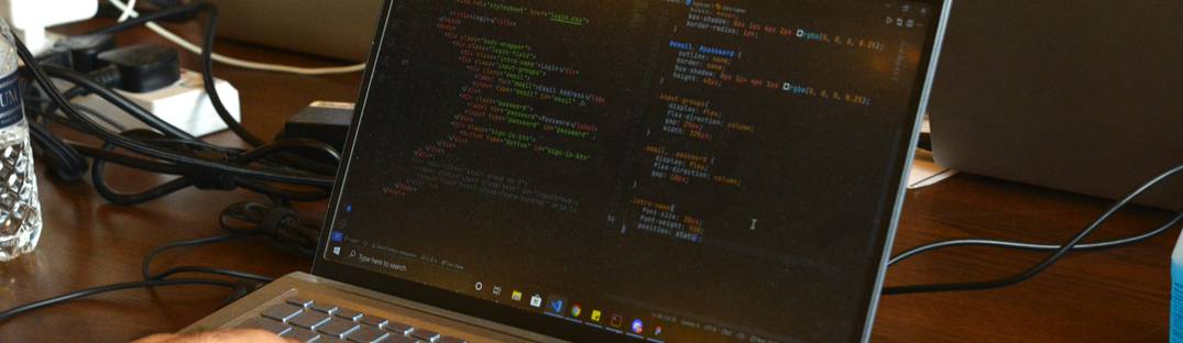 A developer writing secure input validation code on a laptop, representing web form and API security