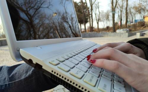 A person reviewing clean, formatted text on a laptop or notepad, symbolizing the editing process