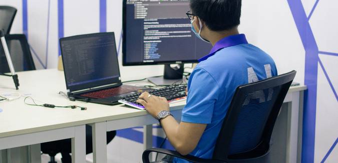 A web developer at a computer decoding URLs in a browser or code editor, digital workspace