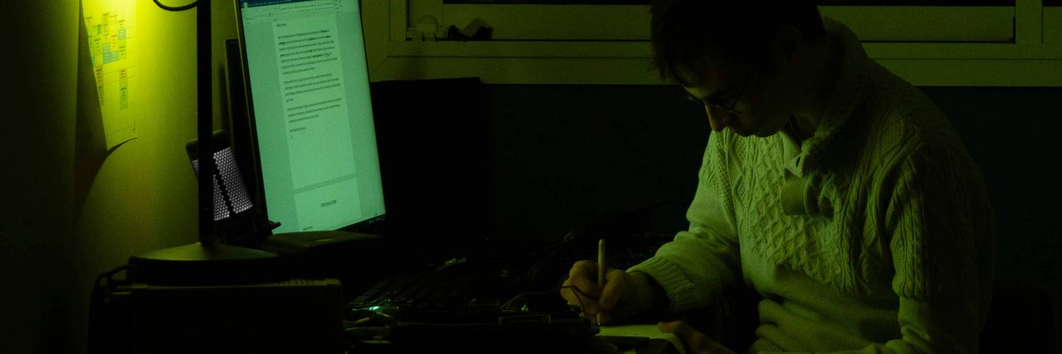 A web developer working at a computer with a digital lock overlay, representing secure coding and web security best practices