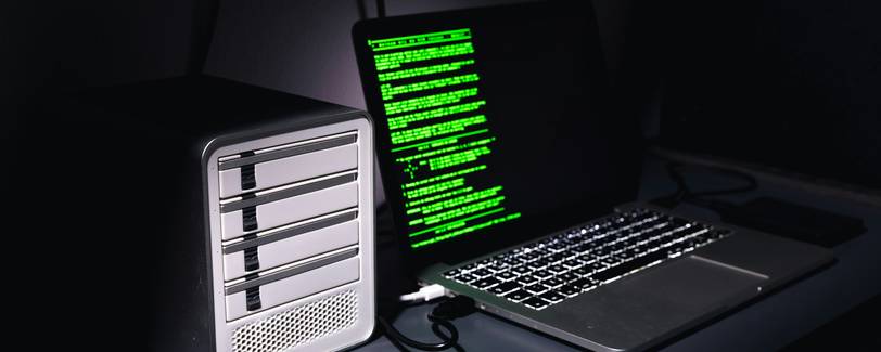 A developer at a computer with code on screen, lock icon overlay, and network diagrams suggesting web security